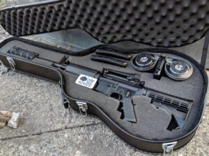 A Discreet Concealment Guitar-Shaped Gun Case showing EPE Cutout Form Fitted With A Rifle and Accessories