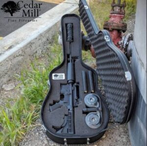 An image showing a guitar-shaped gun case with a rifle and its accessories leaning on a water hydrant