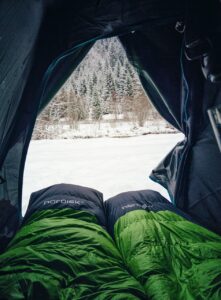 Warm comfy sleeping bags in a snowy cold outdoor camping.